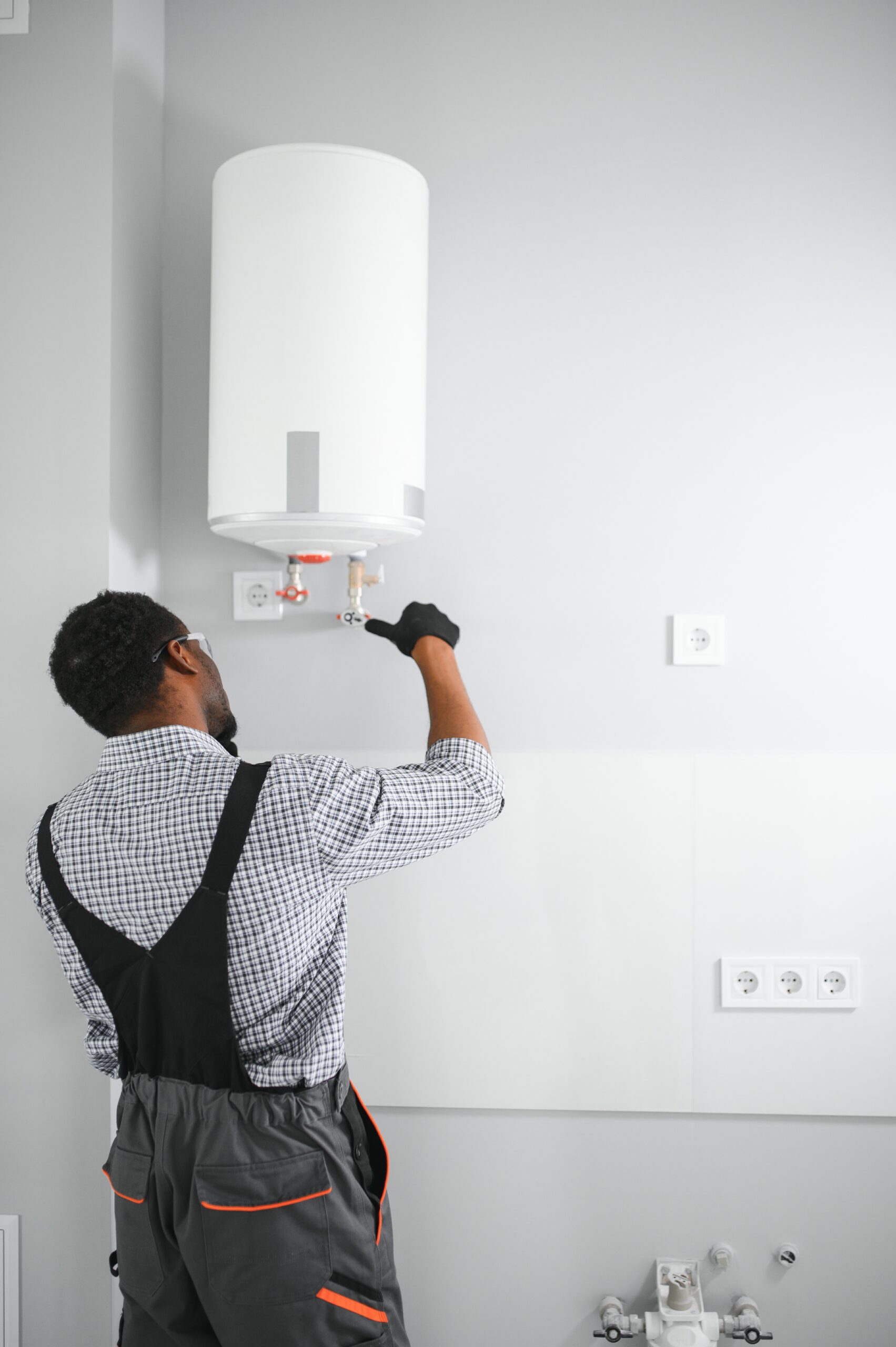 African american worker set up gas heating boiler at home